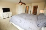 The large master bedroom has a California king bed and is tastefully decorated.